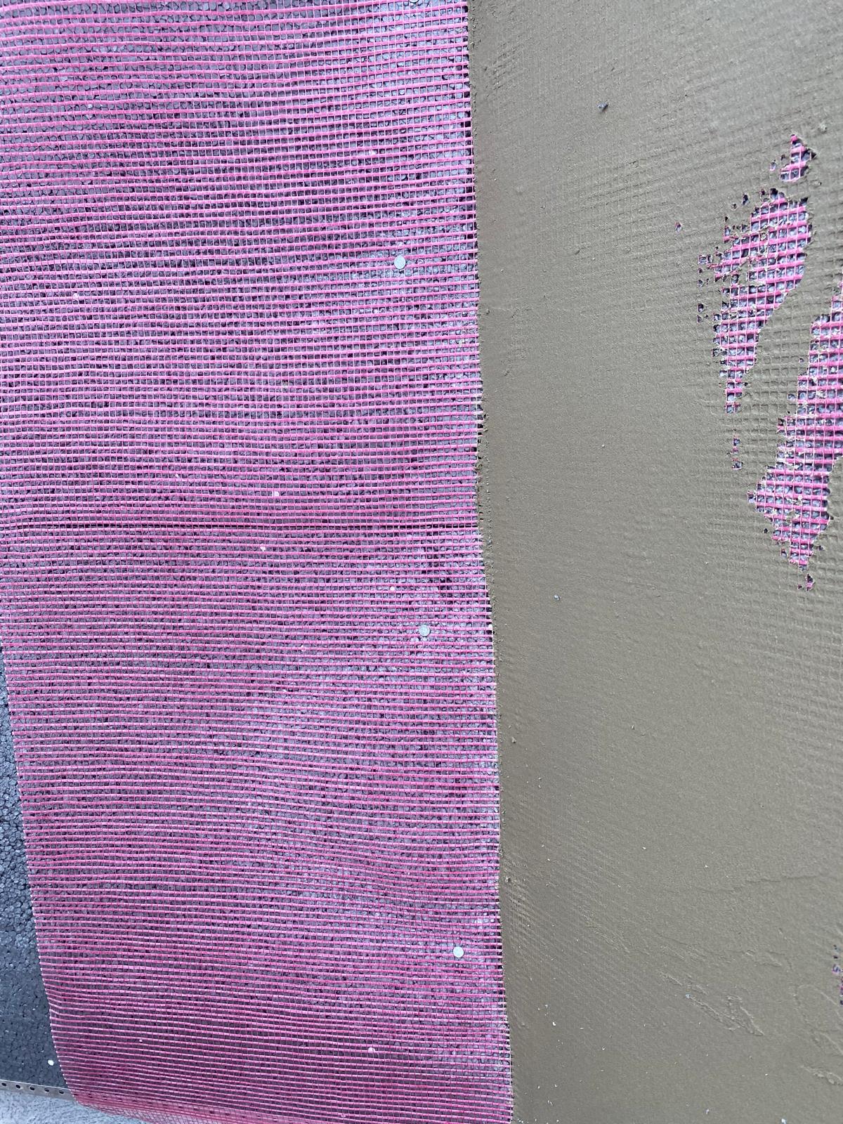 Close-up of Render mesh purple surface next to a smoother gray base coat surface